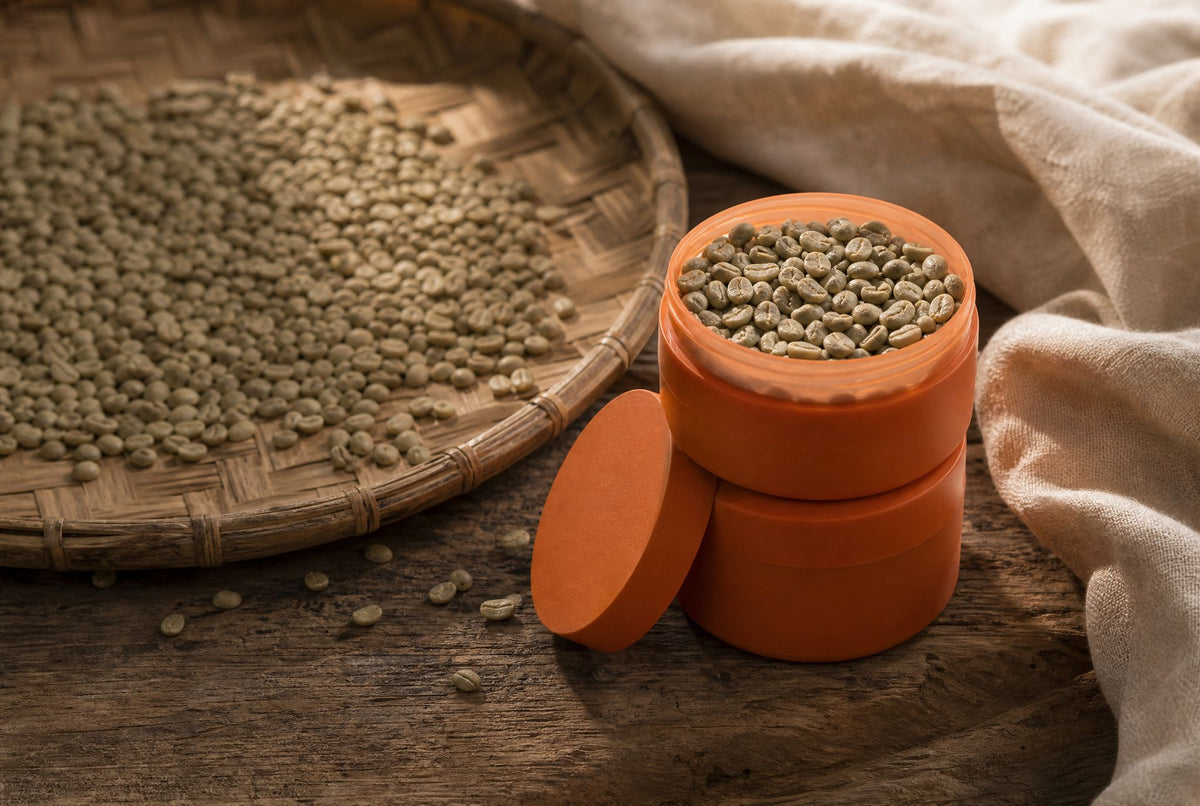 Green coffee beans drying on a woven rattan tray, how mould in coffee happens and is avoided